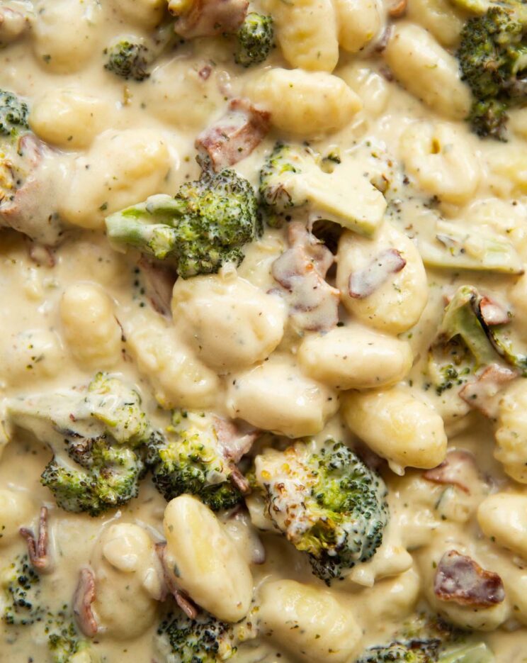 overhead shot of broccoli boursin bacon gnocchi in pan