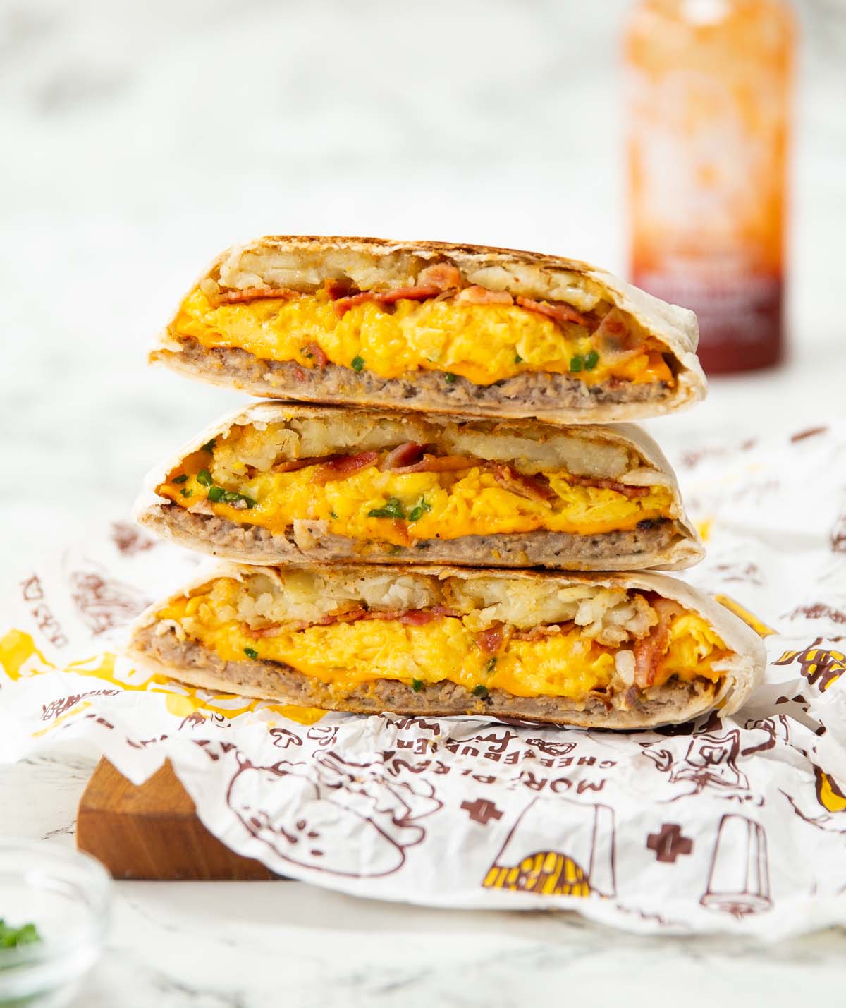 3 breakfast crunchwraps halves stacked on each other showing filling