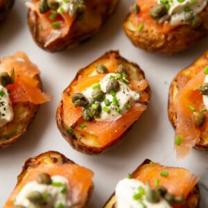 close up shot of smoked salmon potatoes on marble chopping board
